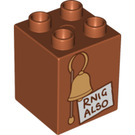 Duplo Dark Orange Brick 2 x 2 x 2 with 'RNIG ALSO' sign and belll (31110 / 93634)