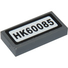 LEGO Dark Stone Gray Tile 1 x 2 with 'HK60085' Sticker with Groove (3069)