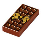 LEGO Rötlich-braun Fliese 1 x 2 mit Chocolate Bar und Gold Bow mit Nut (3069 / 25395)