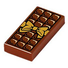 LEGO Reddish Brown Tile 1 x 2 with Chocolate Bar and Gold Bow with Groove (3069 / 25395)